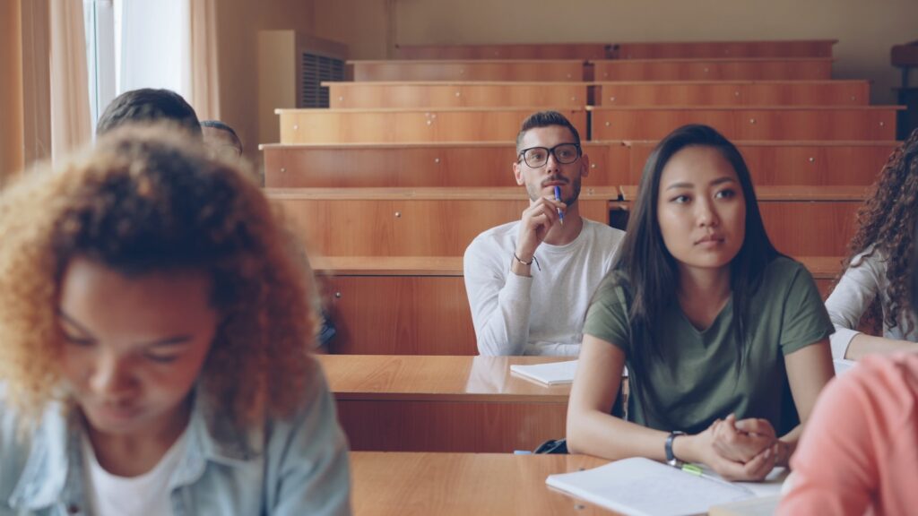 Students listening attentively in a lecture hall.