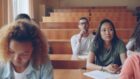 Students listening attentively in a lecture hall.